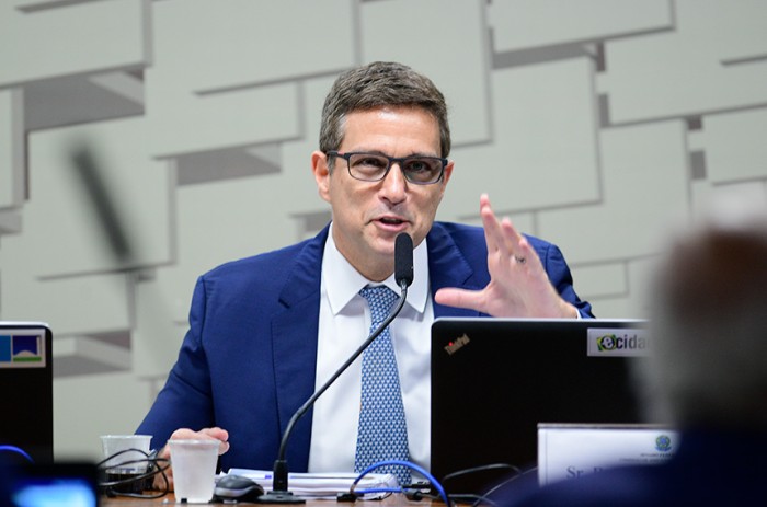 Roberto Campos Neto listou entre as causas de juros altos a "baixa taxa de recuperação de crédito"; a "baixa taxa de poupança"; a "dívida bruta acima da média"; a "percepção de risco"; e a "alta proporção de cr